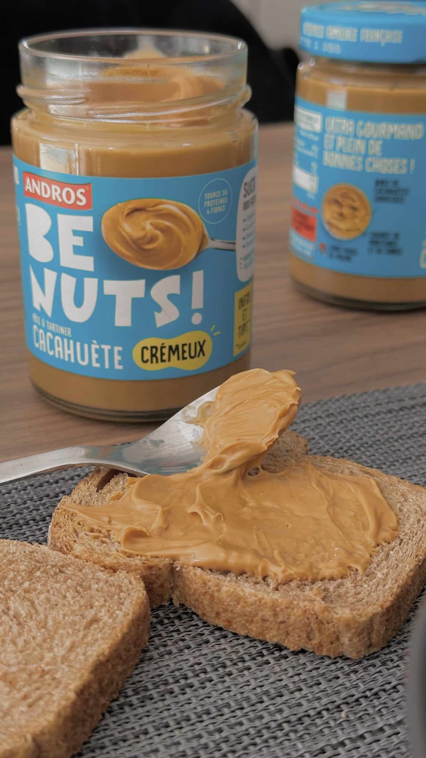 a spoon on a piece of bread with peanut butter